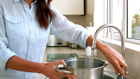 woman filling pot with water