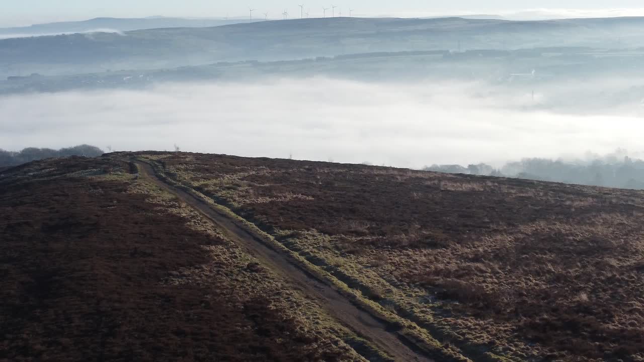 Cloudy misty sunrise valley aerial moorland hiking hillside rural pathway Lancashire pull back