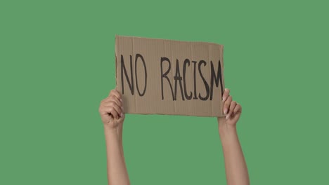 protesting poster with inscription no racism. background to illustrate the movement for the freedom of human rights. female hands holding poster green screen, chroma key. close up. slow motion