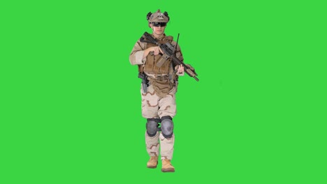 soldier of special force walking and shooting with a rifle on a green screen, chroma key