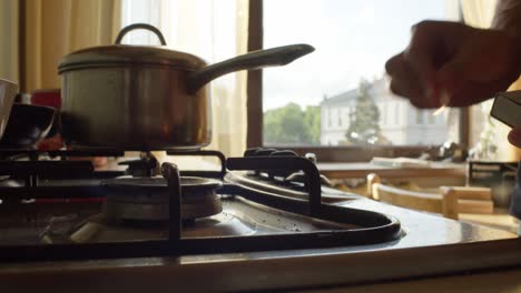 Gasherd-Anzünden-Und-Kaffeekanne-Auf-Brenner-Stellen,-Nahaufnahme,-Zeitlupe