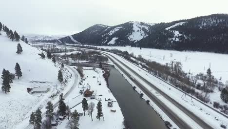 aerial - a light flurry hits the river along the highway