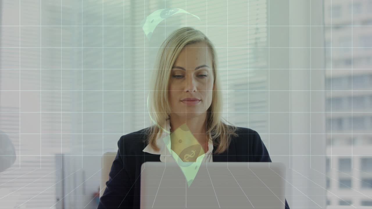 Woman sitting at desk grid and green finance icons sweeping over face smiling at market gains