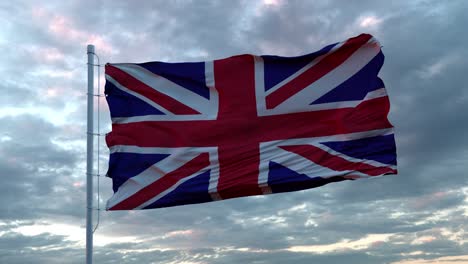 realistic flag of united kingdom waving in the wind against deep dramatic sky. 4k uhd 60 fps slow-motion