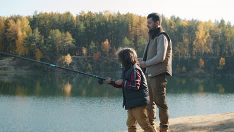 father and son fishing in autumn