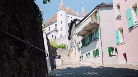 nyon castle at midday, view from an old street in canton of vaud, switzerland, medium shot