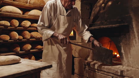 artisan baker working in a traditional bread oven