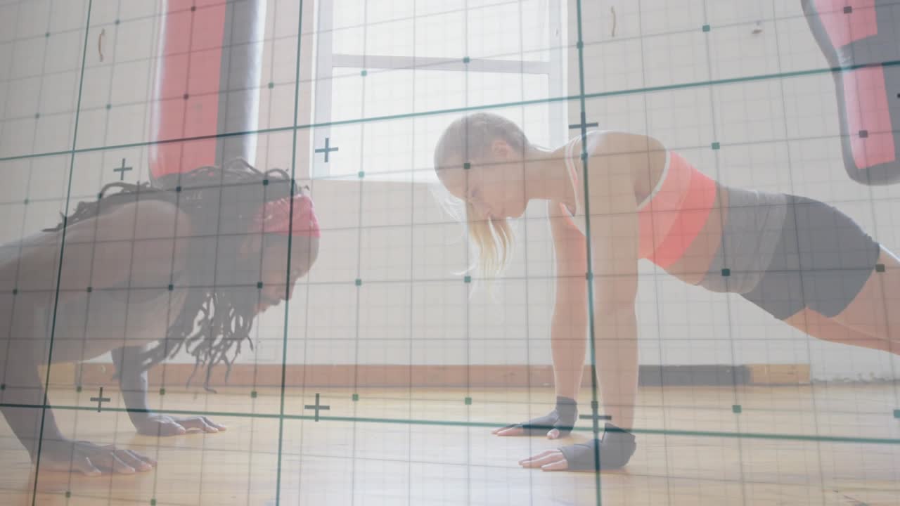 Partners following rhythmic cue, doing pushups on studio floor grid tracking motion for fitness