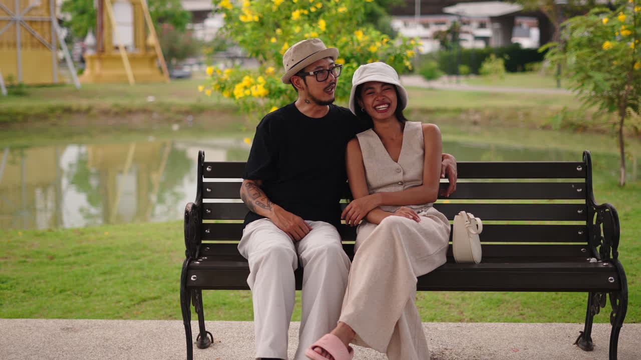 Couple sitting on a bench in a park