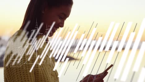 animation of graphs over hands of biracial woman using smartphone