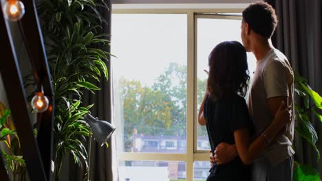 Side-view-of-young-asian-couple-embracing-each-other-at-home-4k