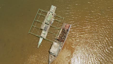 orbital drone view over shipwrecks beached in murky shallow waters in surigao, philippines