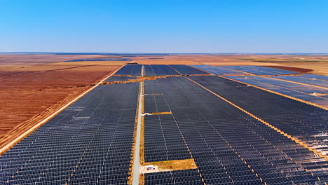 Vast fields covered with solar panels. Drone flight over the open space used for sustainable energy production