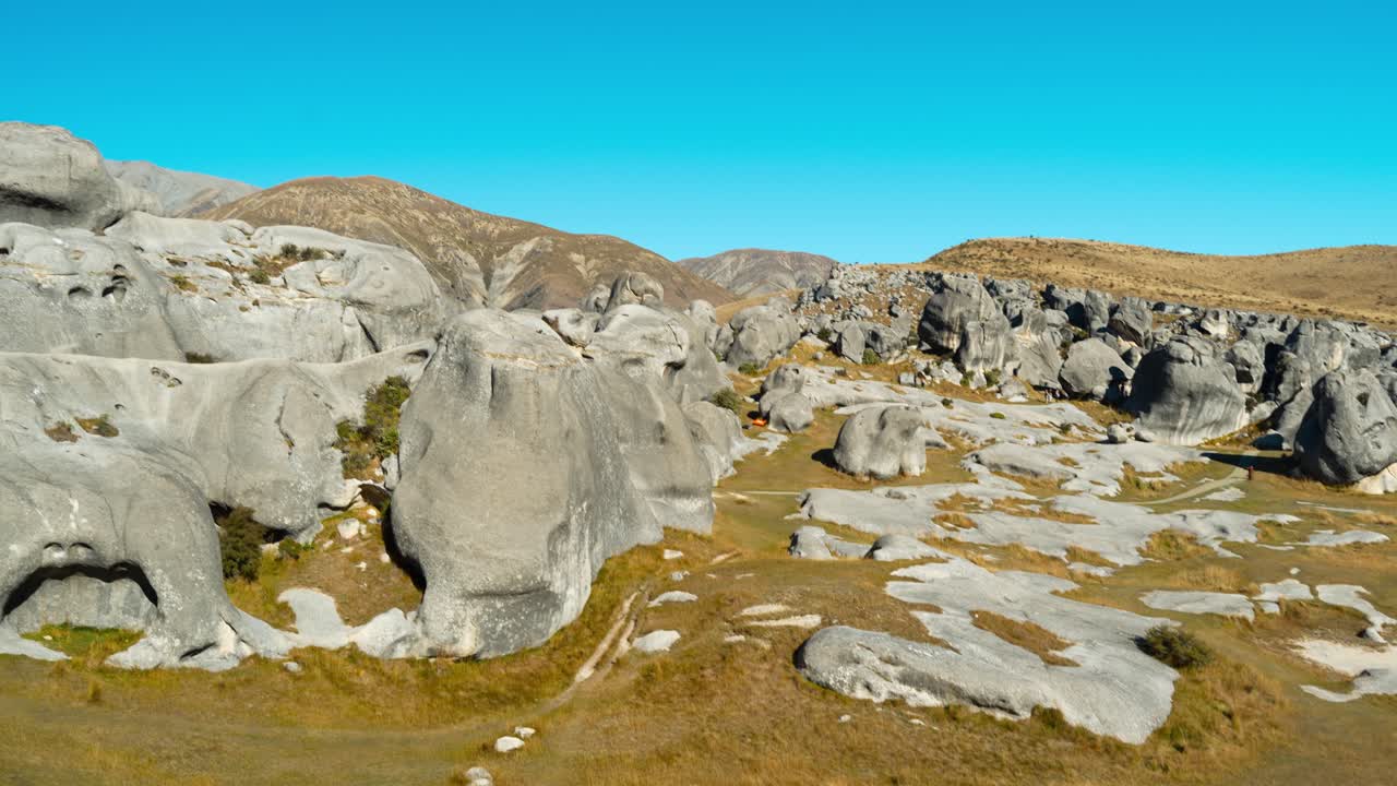 Girl Posing by Boulders of Maori Site of Castle Hill in Arthur's Pass, New Zealand