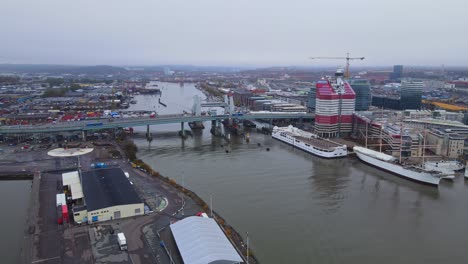 old gota alv bridge in gothenburg, sweden next to a new bridge being constructed with view of the lilla bommen building, aerial drone