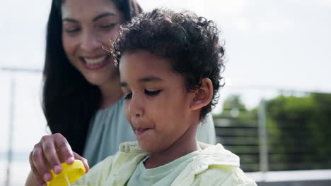 outdoor, mother and child blowing bubbles