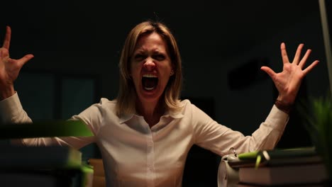 woman overwhelmed and screaming in frustration at her desk