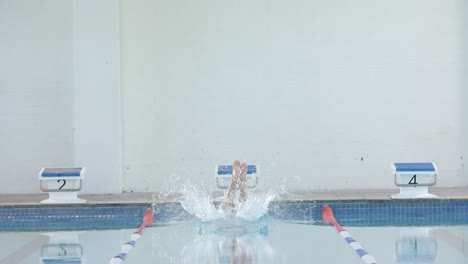 swimmer making a splash in an indoor pool