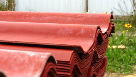 stack of red corrugated roofing sheets