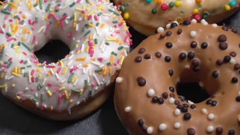 sweet donuts spinning on a dark background. traditional american sweetness
