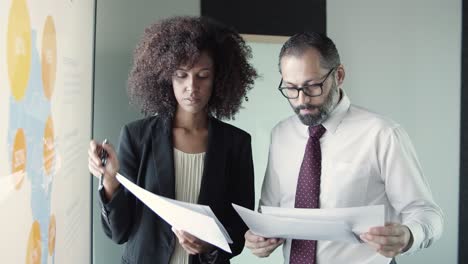 african american businesswoman showing report to boss