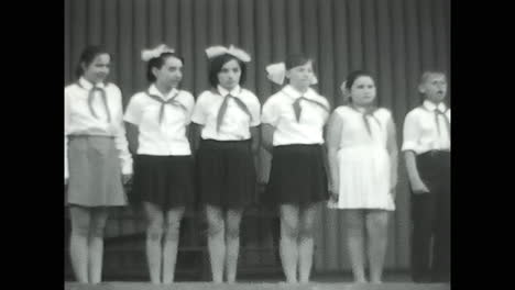 group of young pioneers standing on stage. circa ussr 1970: group of young pioneers standing on stage