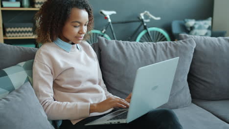 young woman working on laptop at home