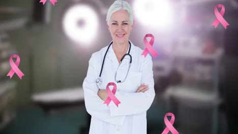 Animation-of-breast-cancer-awareness-ribbons-over-happy-caucasian-female-doctor