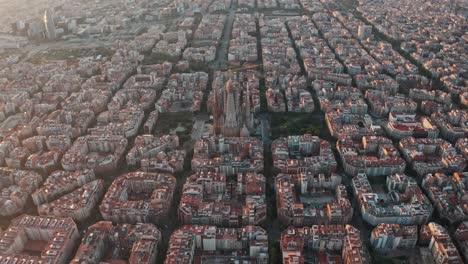 descending drone shot of sagrada familia at sunrise