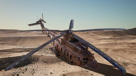 old rusted military helicopter in the desert at sunset