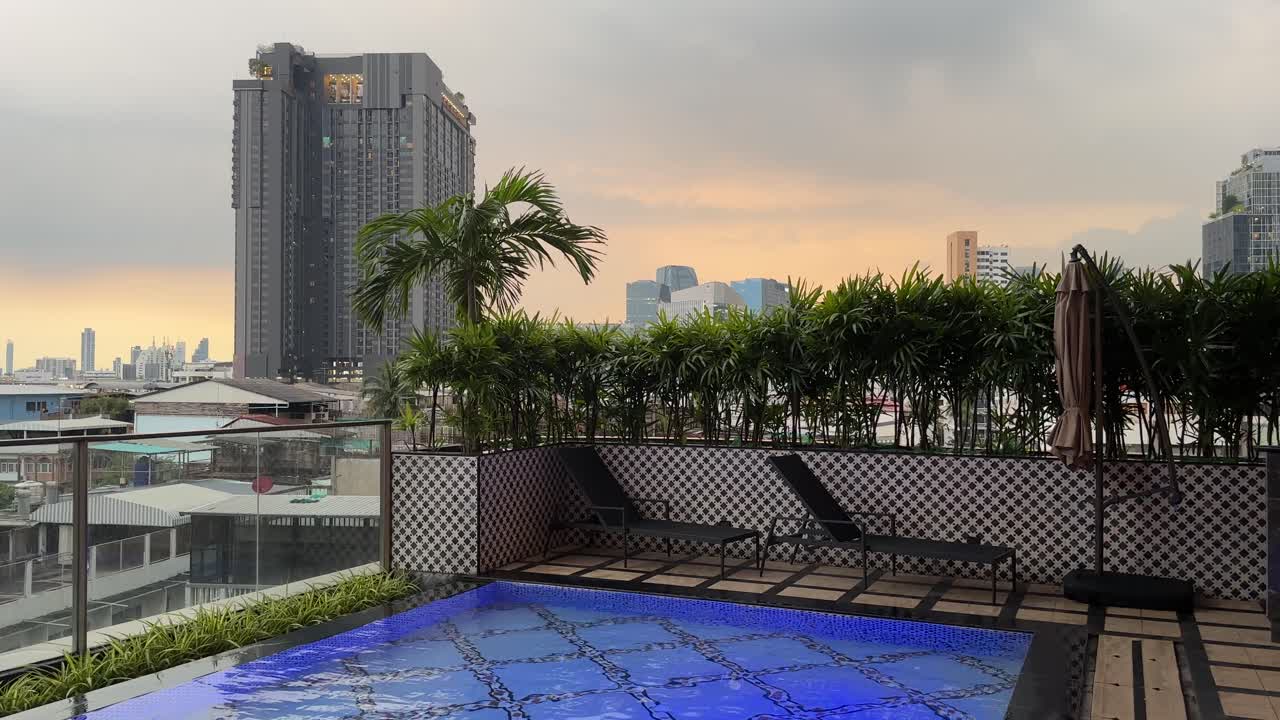 Stunning Rooftop Pool with City Skyline at Sunset
