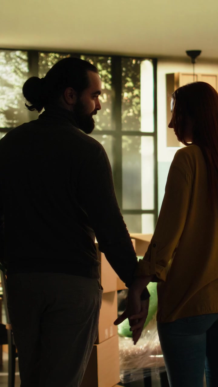 Vertical Video Proud couple holding hands enjoying new house achievement