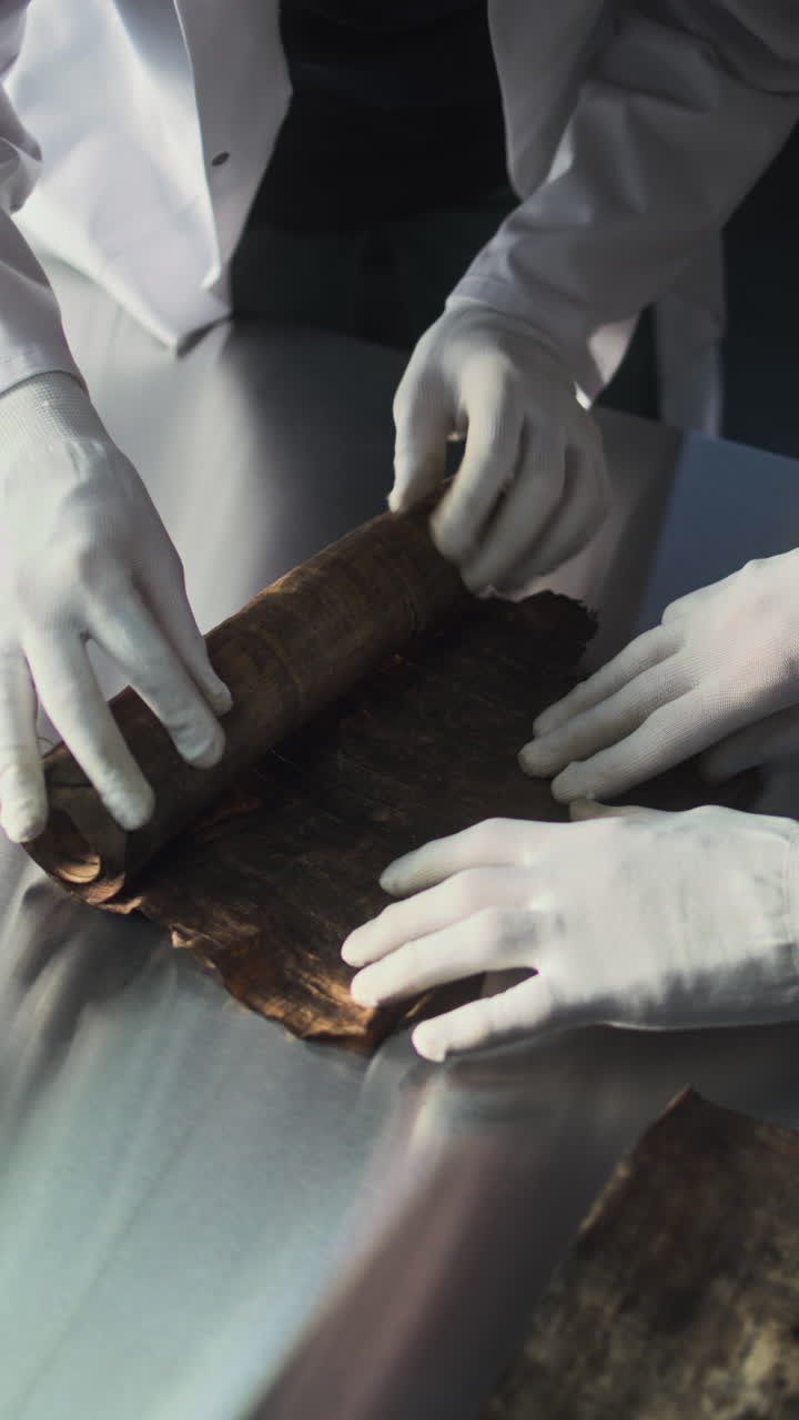 Experts Examining an Ancient Papyrus Scroll