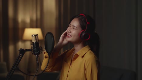 asian female singer singing in home studio