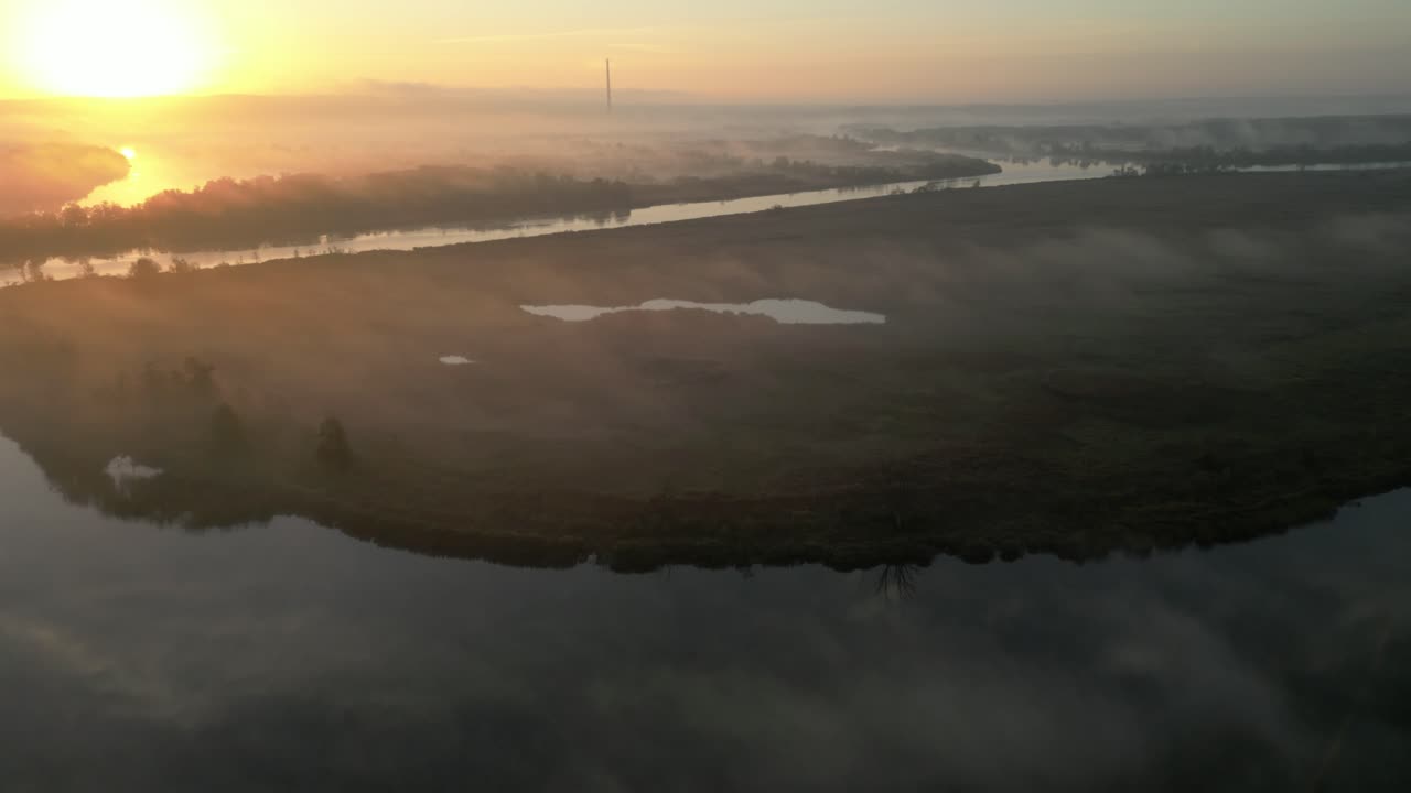 Misty sunrise over the Odra River in Poland with fog drifting across the tranquil water