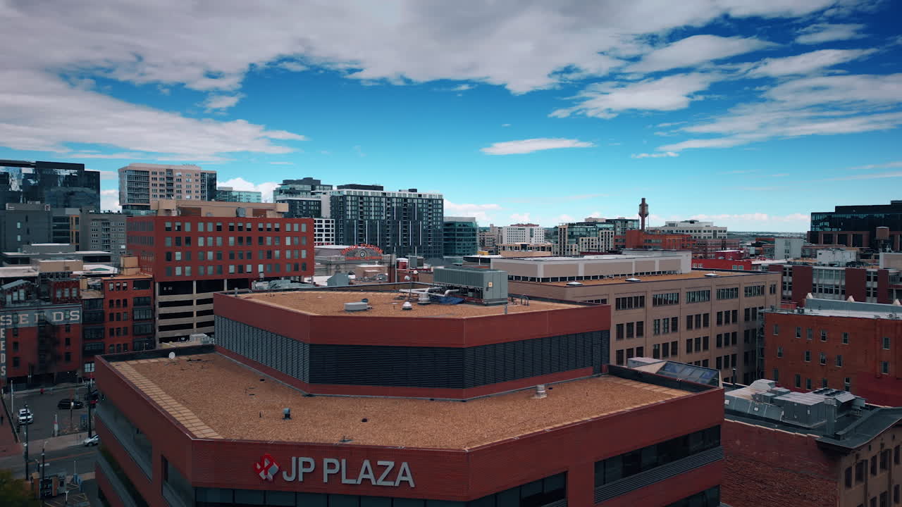 Denver, USA, 24 August 2025: Going up over the tops of modern high-rise building. Cityscape of Denver, Colorado, USA at the backdrop of cloudy sky