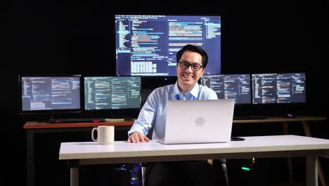 smiling programmer at a modern workspace