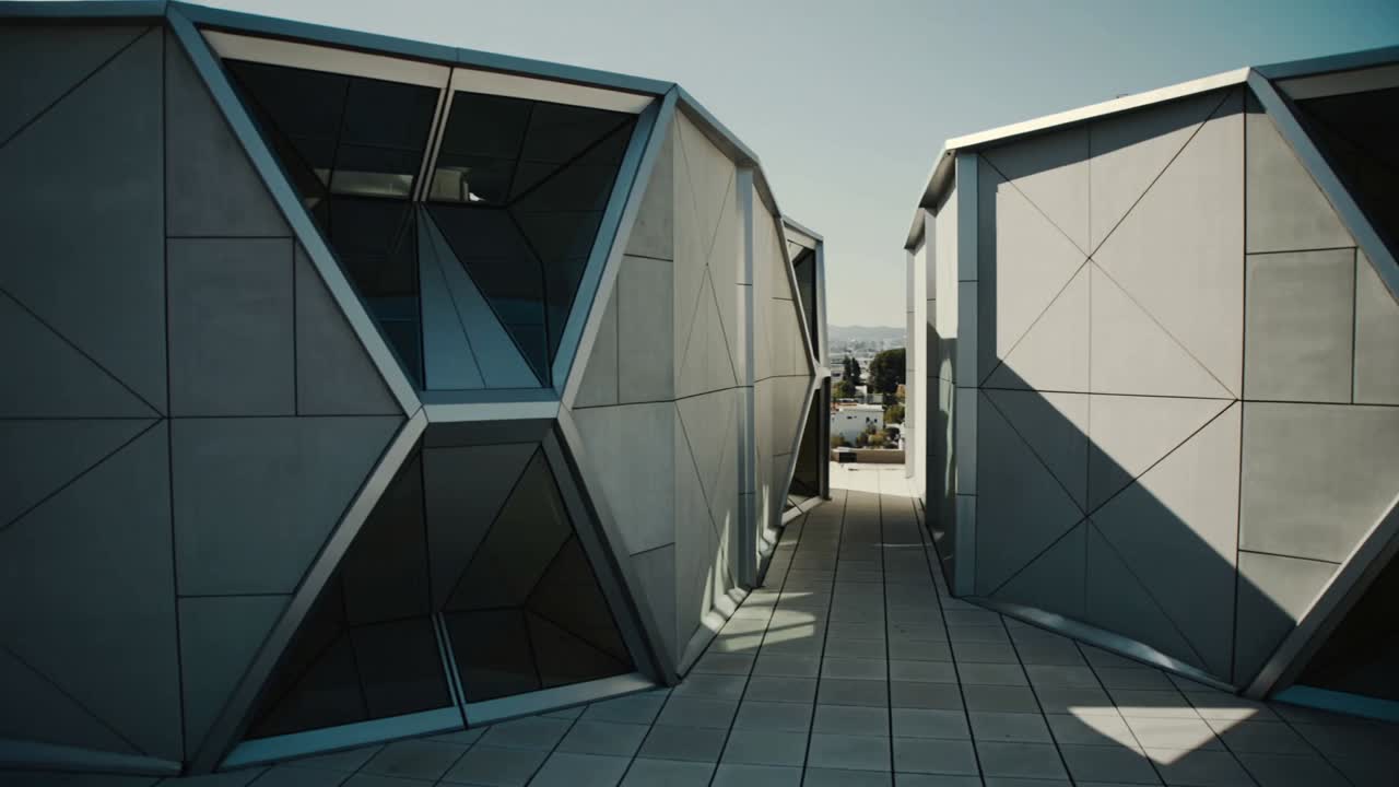 Starting playback, camera panning right along tiled walkway between metal facades with windows