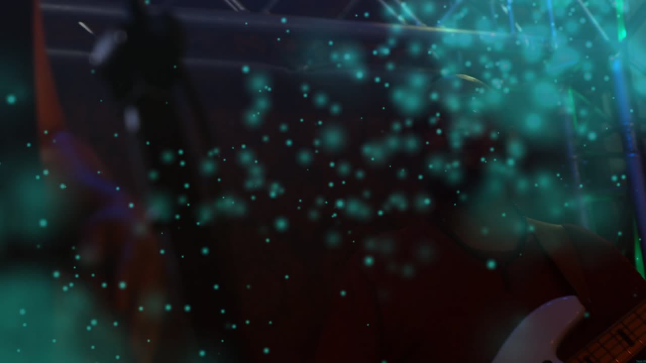 Male bassist playing on dim music stage, teal particles thinning to reveal white bass for concert