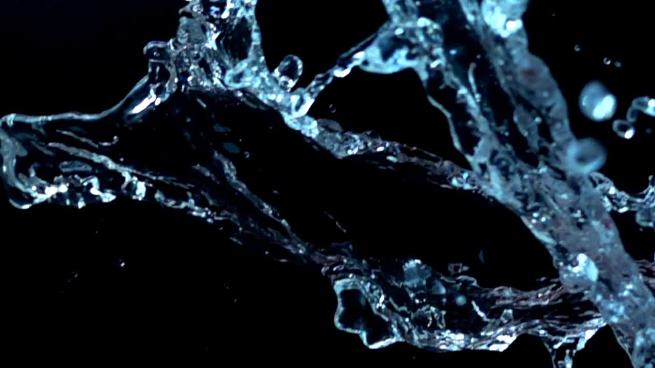 Water on a black background. Slow motion
