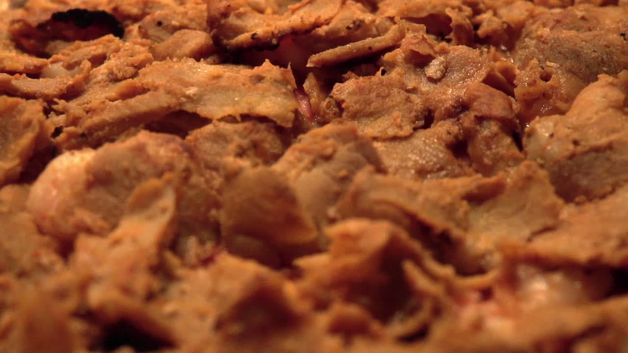 Close up footage of a delicious swedish pizza. Topped with kebab meat. Slow motion footage