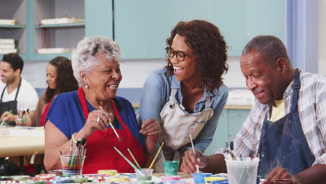 Group-Of-Retired-Seniors-Attending-Art-Class-In-Community-Centre-With-Teacher