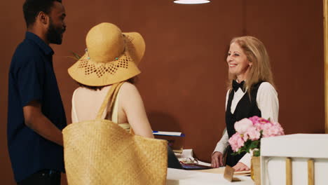 hotel employee welcoming tourists