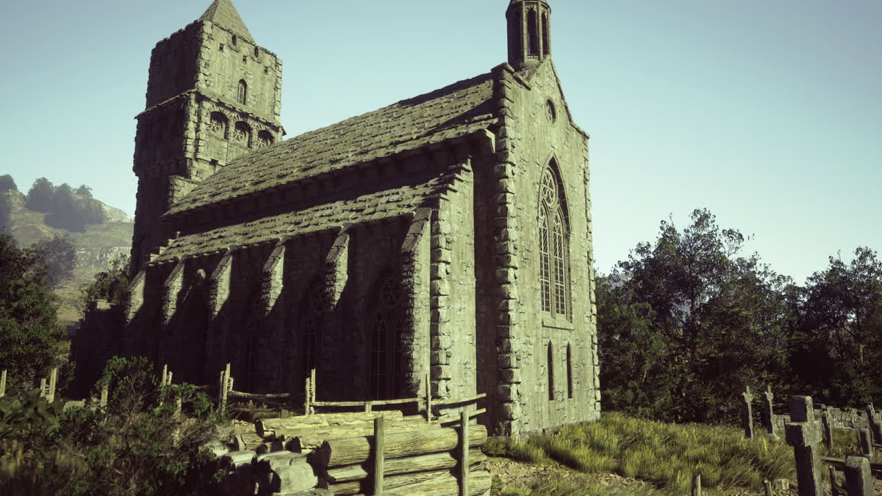 Historic stone church surrounded by lush greenery and mountains during daylight