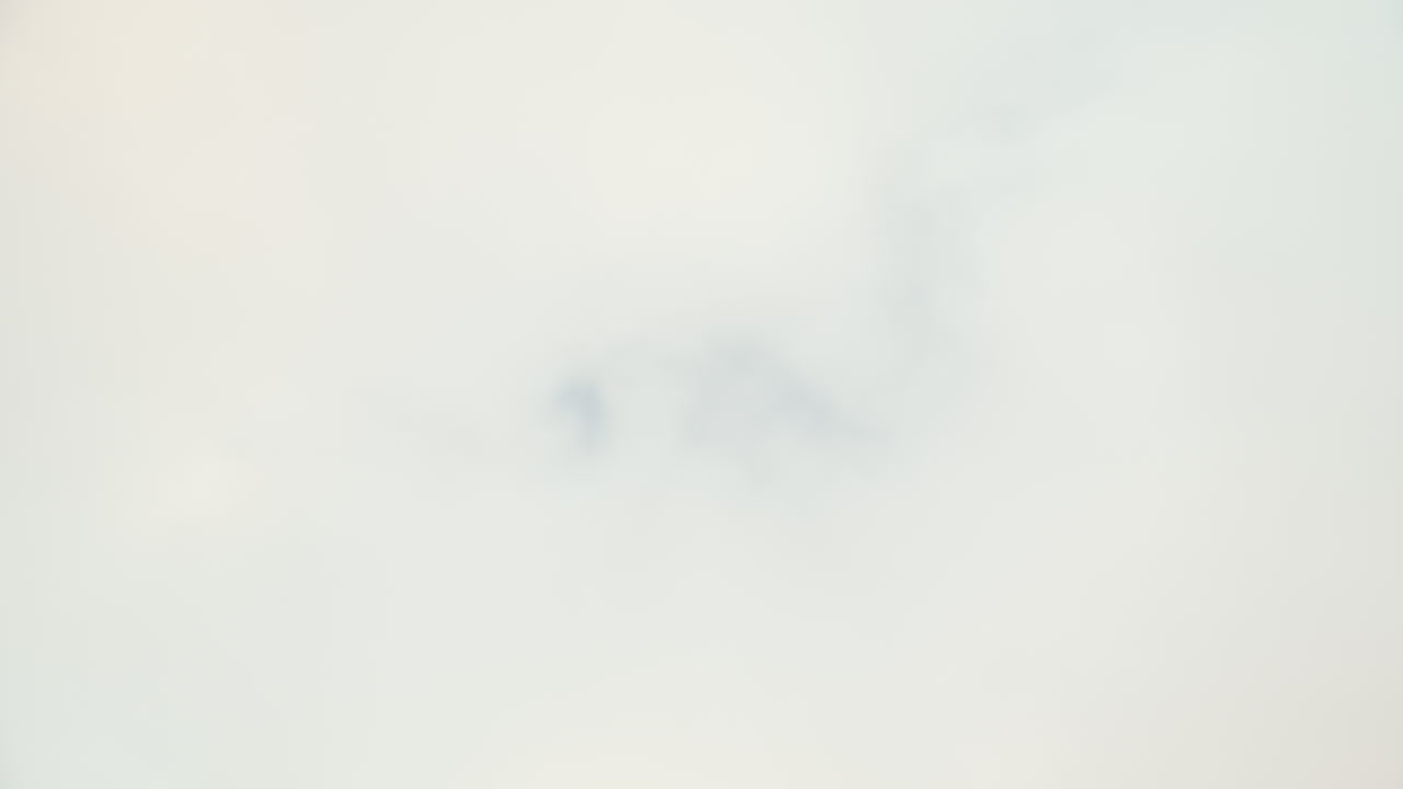 View against the cloudy sky while runner is jumping over the camera