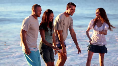 Cheerful-group-of-friends-dancing-on-the-beach