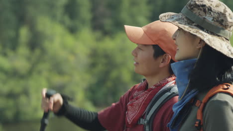 two asian female hikers discussing nature