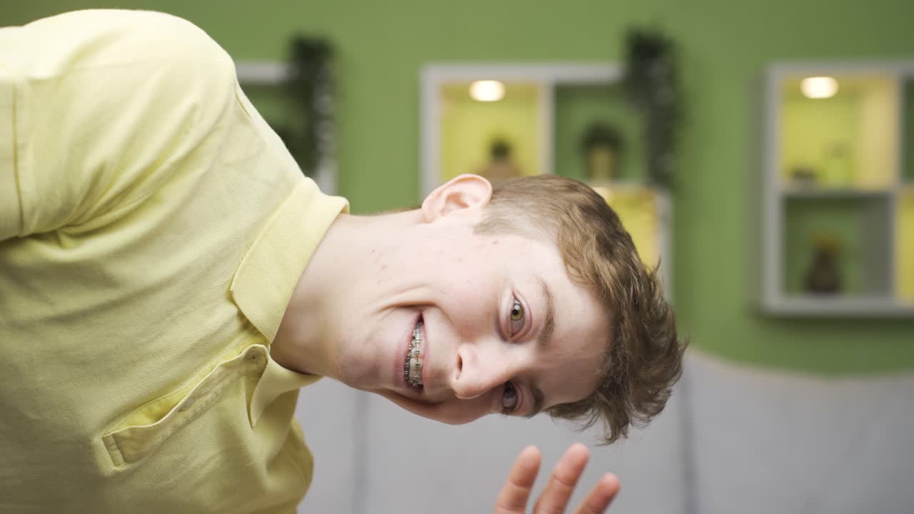 Close-up portrait of cheerful young man looking at camera.
