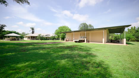 large shed surround by green lawn and leafy trees