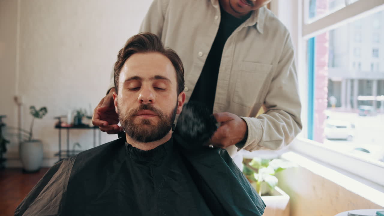 Barber Brushing Client's Beard After a Trim in a Modern Barbershop